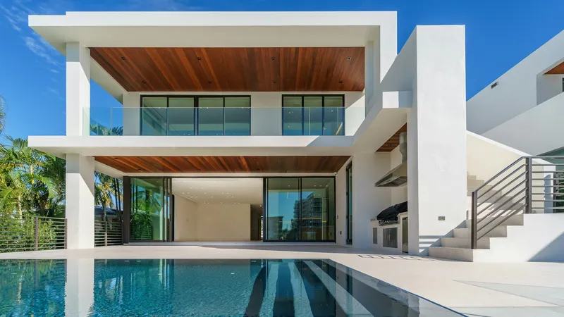 Pool and equipment area at a modern Florida home with palm trees