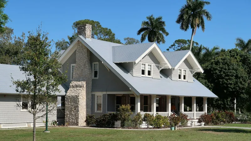 Florida home with dormered addition under royal palms